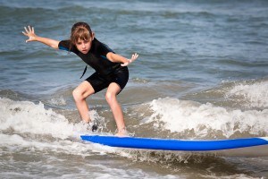 Young surfer girl is riding a wave