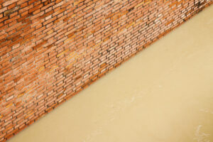 Brick wall with flood water.